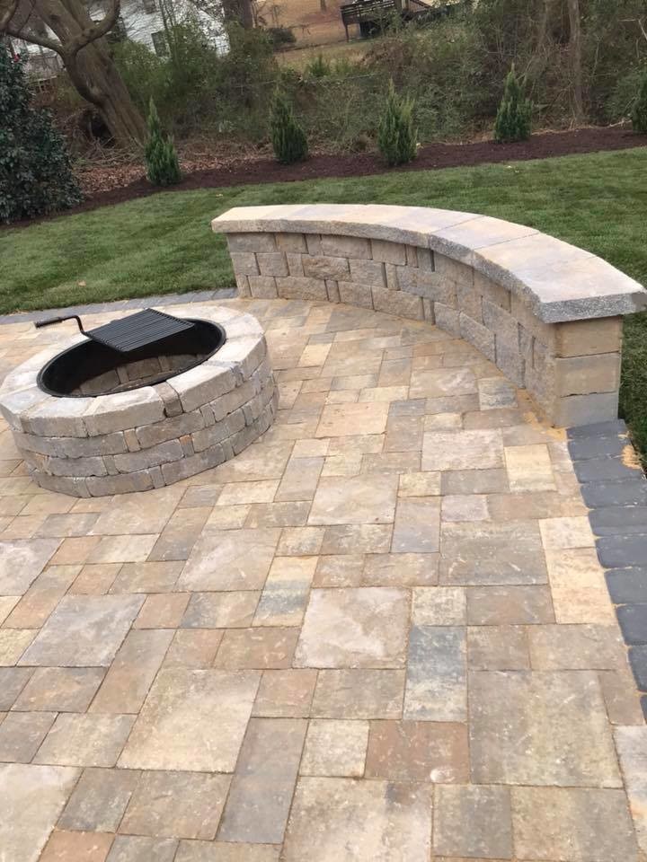 Photo of a mid-sized traditional backyard garden in Atlanta with a retaining wall and concrete pavers.