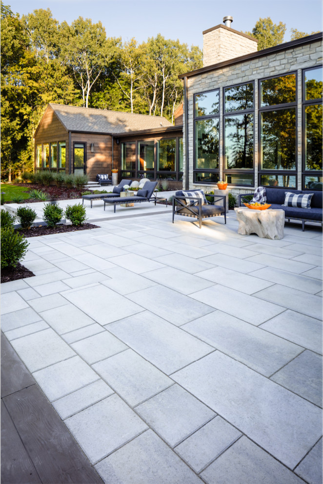 Mountain style backyard concrete patio photo in Philadelphia with a fire pit