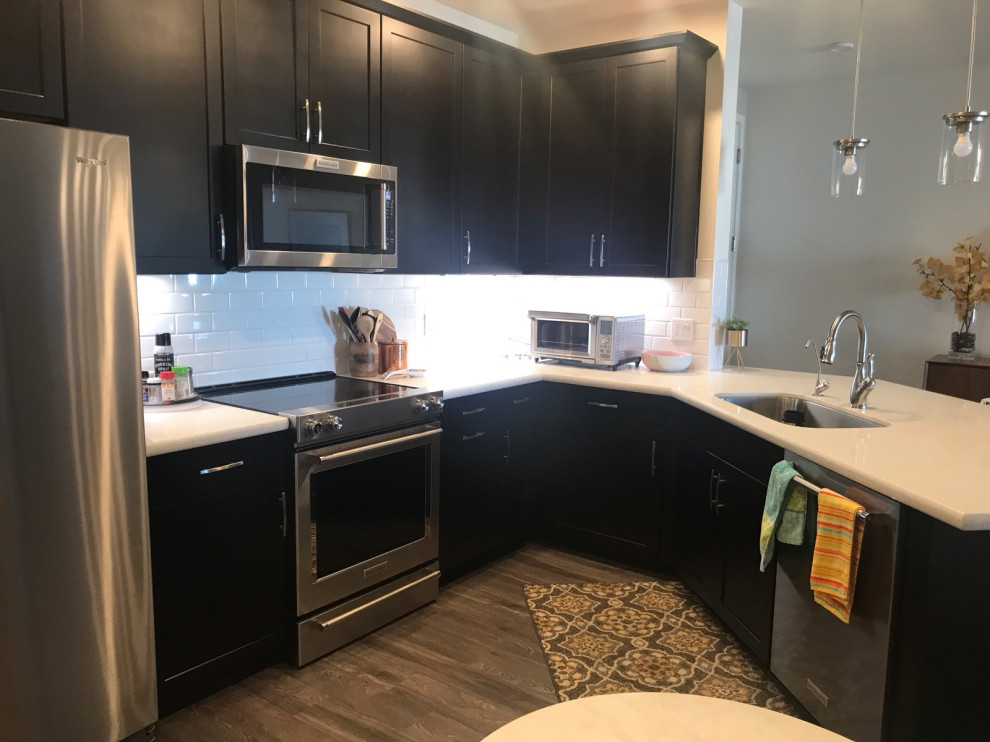 View of How to change kitchen with black cabinets and pendant lighting