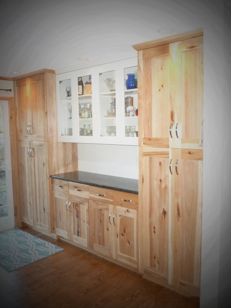Large mountain style medium tone wood floor and brown floor closet photo in Seattle with shaker cabinets and light wood cabinets