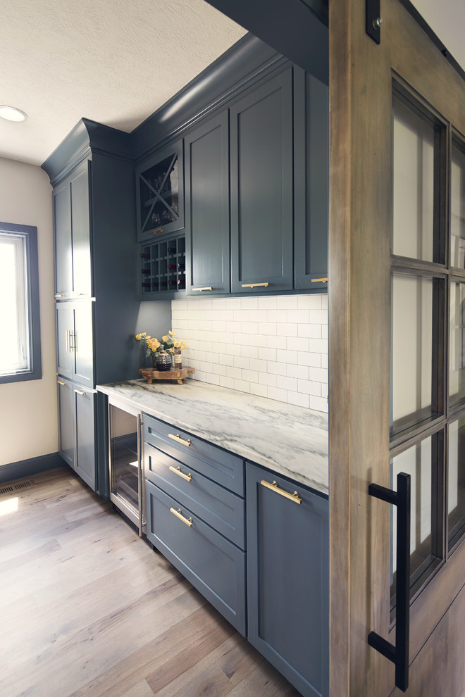 Example of a large mountain style medium tone wood floor wine cellar design with storage racks