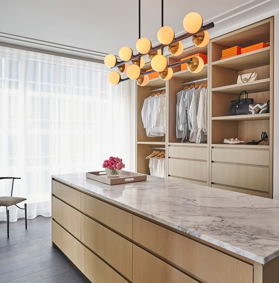 Design ideas for a contemporary storage and wardrobe in Chicago with flat-panel cabinets, light wood cabinets and white floor.
