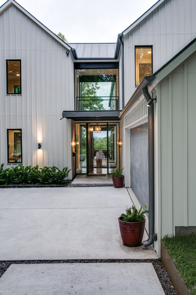 Inspiration for a large modern two-storey grey exterior in Dallas with wood siding.