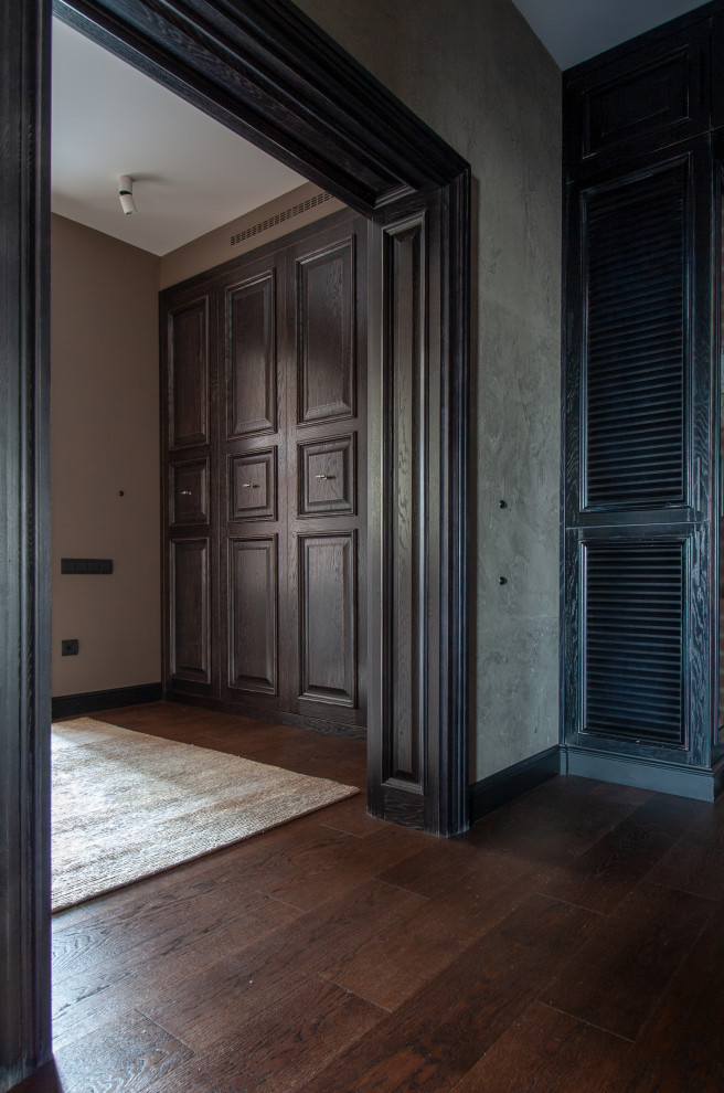 This is an example of a contemporary hallway in Moscow with dark hardwood floors.