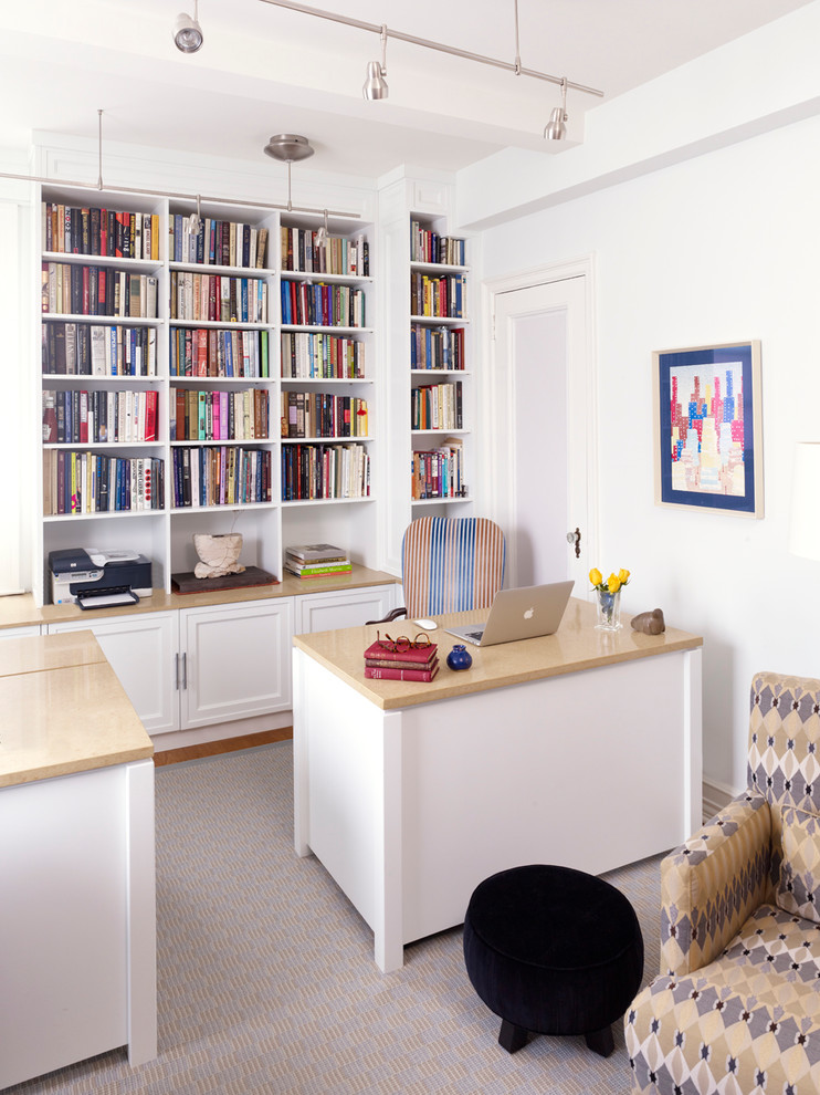 Transitional home office in New York with white walls and a freestanding desk.