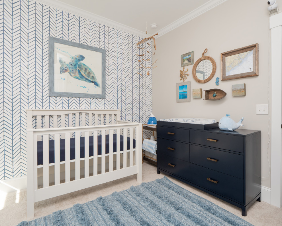 This is an example of a mid-sized beach style nursery for boys in Charleston with beige walls, carpet and beige floor.