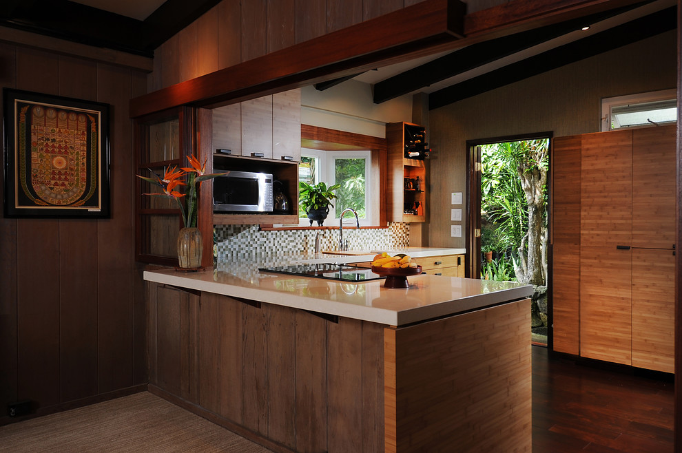 Design ideas for a mid-sized tropical u-shaped kitchen pantry in Hawaii with flat-panel cabinets, quartzite benchtops, green splashback, mosaic tile splashback, an undermount sink, medium wood cabinets and stainless steel appliances.