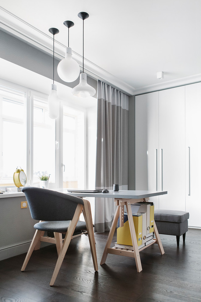 Inspiration for a contemporary study room in Moscow with grey walls, dark hardwood floors and a freestanding desk.