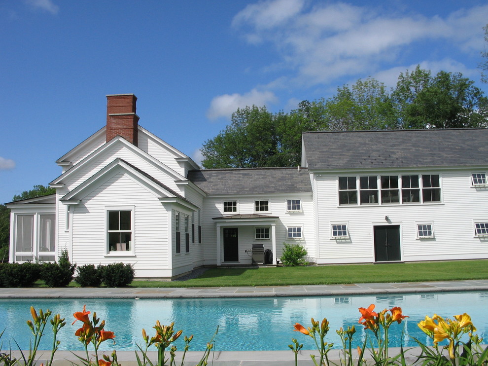 This is an example of a traditional rectangular pool in Boston with natural stone pavers.