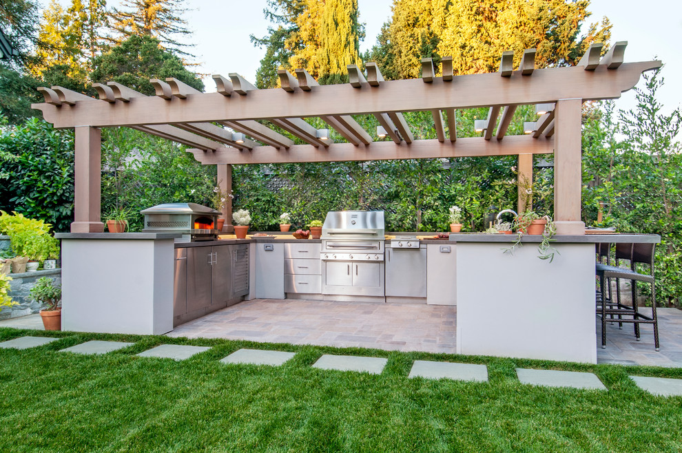Large backyard patio in San Francisco with an outdoor kitchen and a pergola.