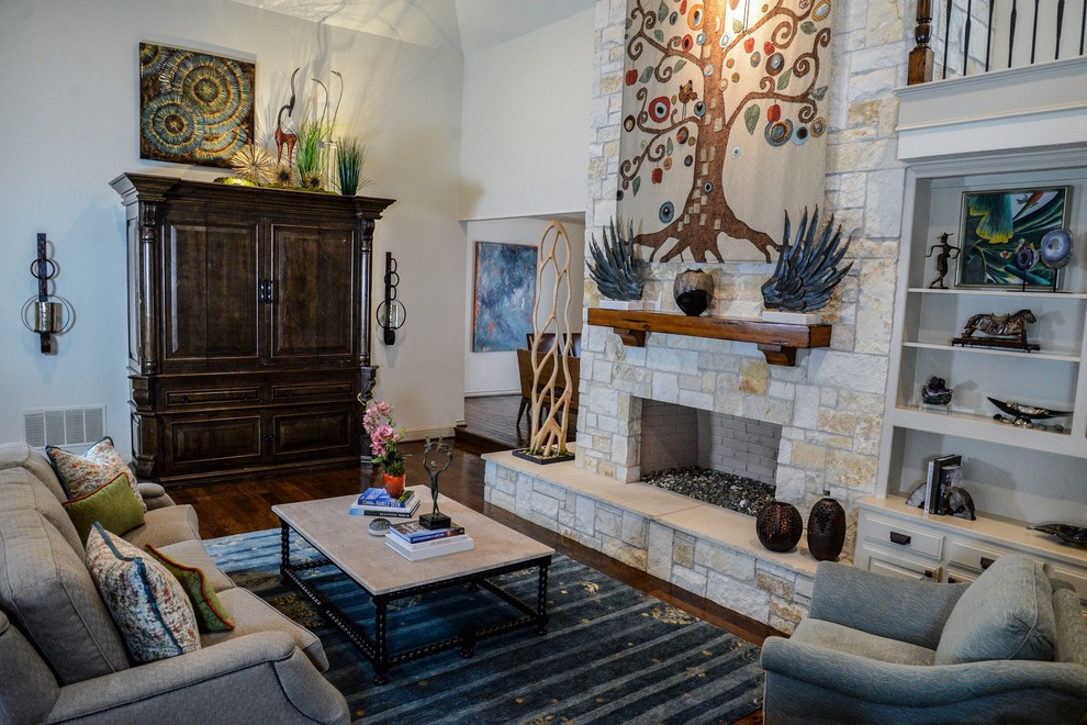 This is an example of a mid-sized country open concept living room in Dallas with medium hardwood floors, a standard fireplace, a stone fireplace surround, no tv, white walls and brown floor.