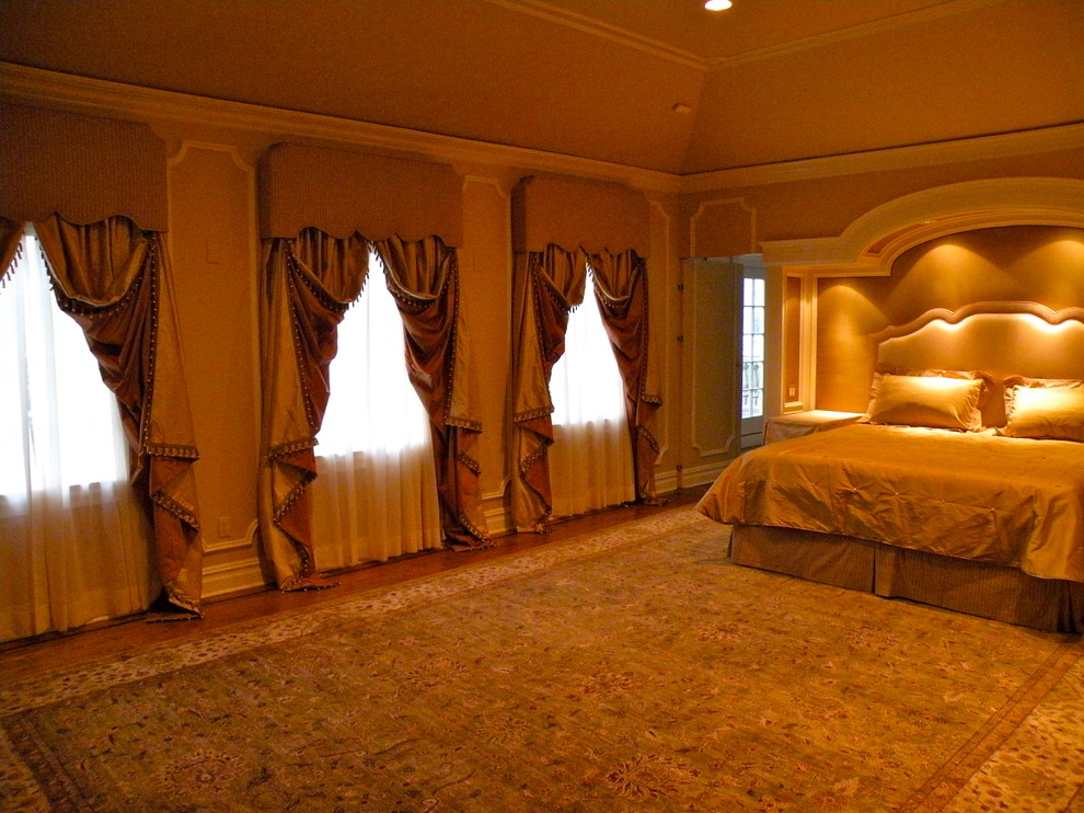 Mid-sized master bedroom in New York with carpet and a two-sided fireplace.