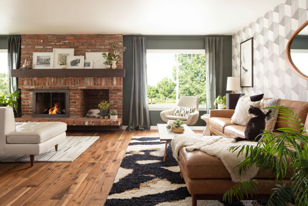 Inspiration for a large retro open plan living room in Denver with green walls, medium hardwood flooring, a standard fireplace, a brick fireplace surround, brown floors, a drop ceiling and wallpapered walls.
