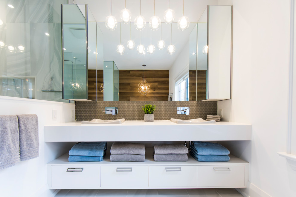 Photo of a mid-sized contemporary master bathroom in Toronto with open cabinets, medium wood cabinets, a freestanding tub, a corner shower, a one-piece toilet, white tile, porcelain tile, white walls, porcelain floors, a drop-in sink, solid surface benchtops, white floor, a hinged shower door and white benchtops.