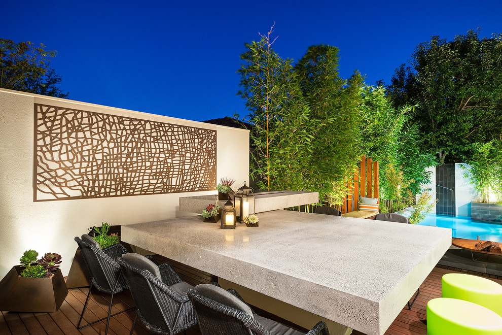 Contemporary backyard deck in Melbourne with no cover.