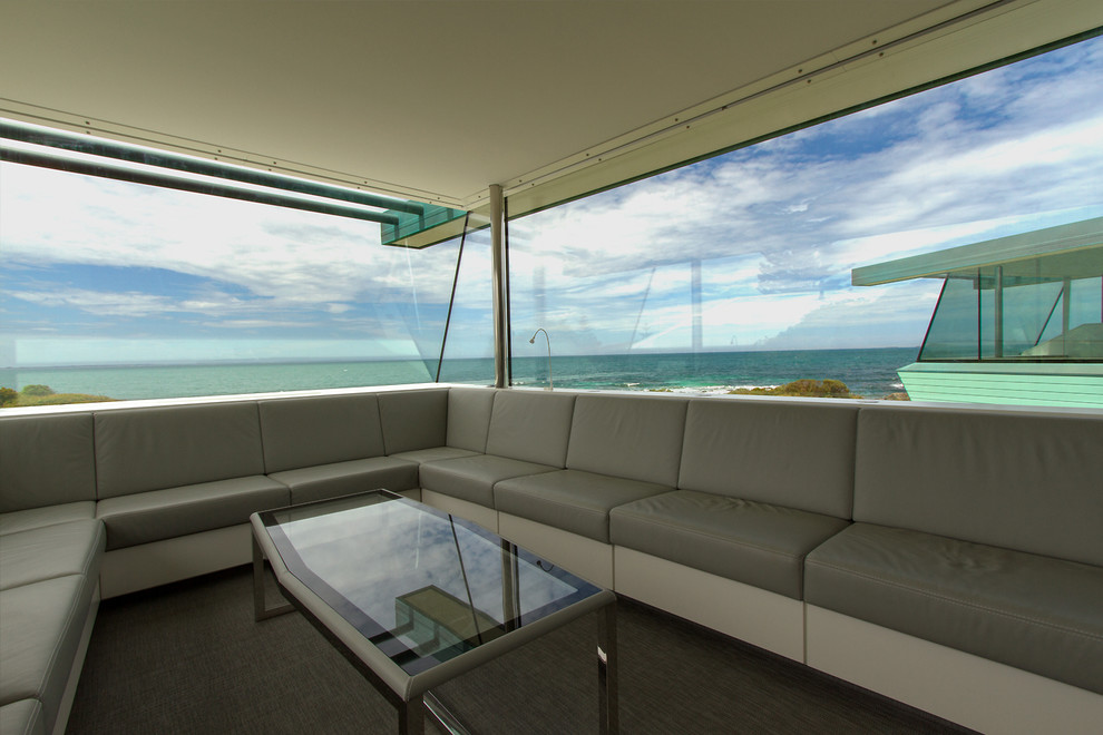 Design ideas for a mid-sized contemporary open concept living room in Perth with white walls and a concrete fireplace surround.
