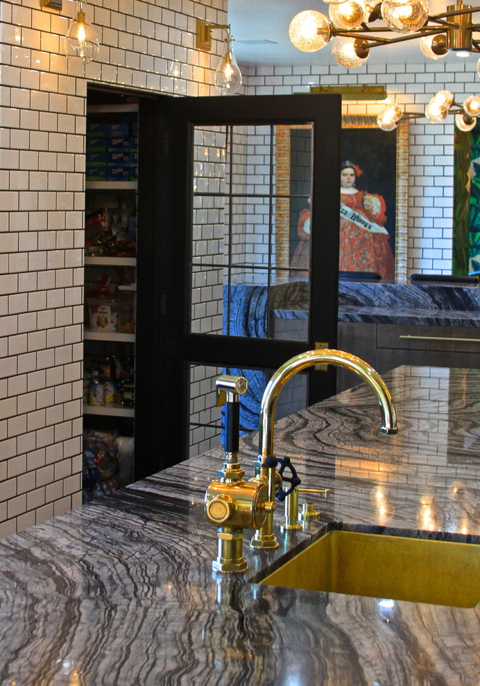 Inspiration for a huge eclectic l-shaped ceramic tile enclosed kitchen remodel in Orange County with an undermount sink, flat-panel cabinets, gray cabinets, marble countertops, white backsplash, subway tile backsplash, black appliances and an island