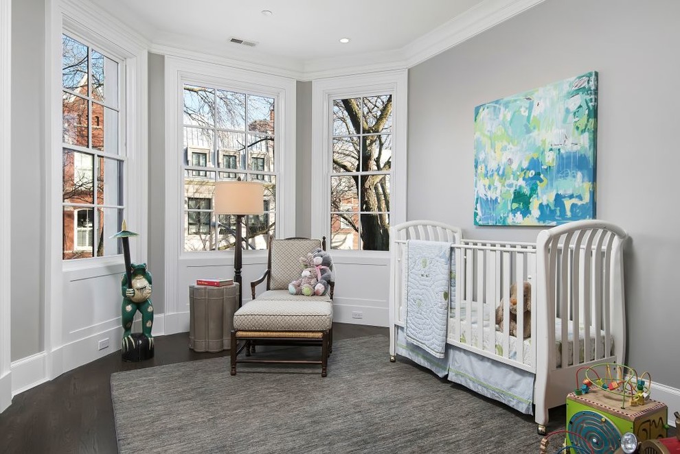 Design ideas for a mid-sized nursery for boys in Chicago with beige walls and dark hardwood floors.