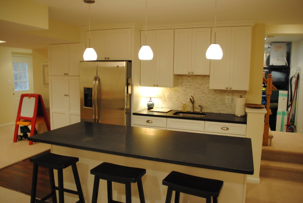 Example of a mid-sized dark wood floor eat-in kitchen design in DC Metro with white cabinets, ceramic backsplash and an island