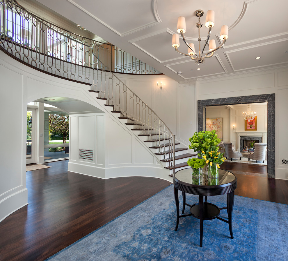Traditional foyer in Los Angeles with white walls, dark hardwood floors and brown floor.