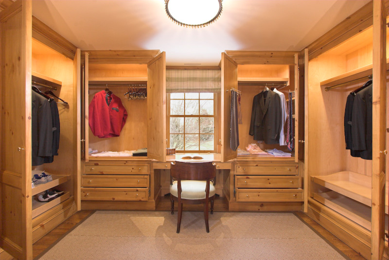 Large traditional storage and wardrobe in New York with light wood cabinets.