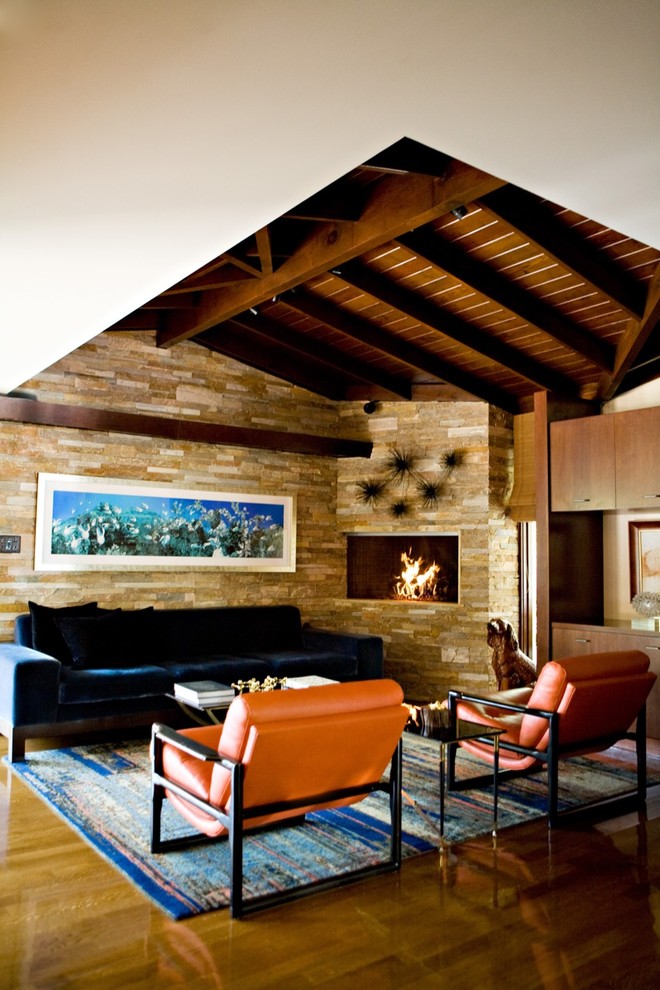 Mid-sized midcentury open concept family room in Los Angeles with medium hardwood floors, a stone fireplace surround, a home bar, beige walls, a ribbon fireplace, no tv and brown floor.