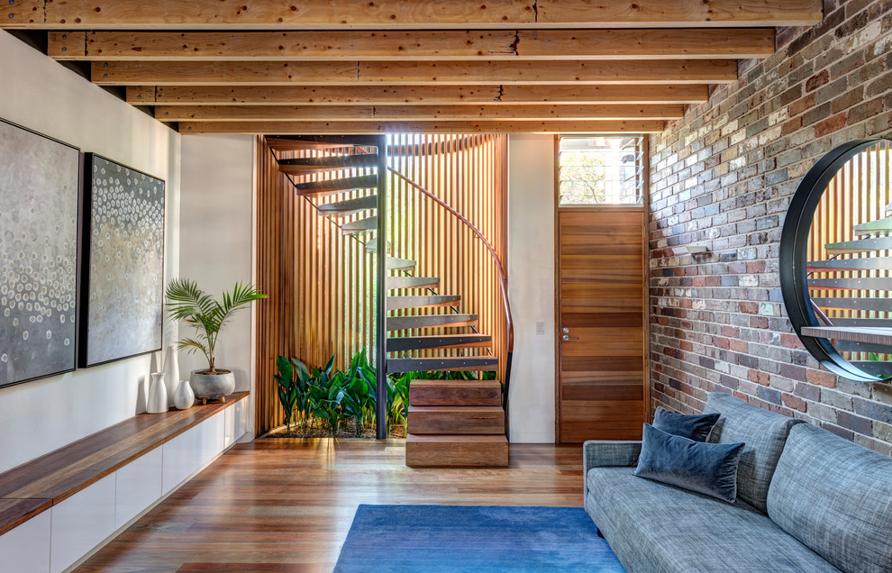 Design ideas for a small modern wood spiral staircase in Sydney with open risers and wood railing.