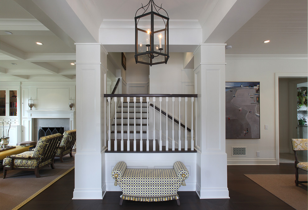 Photo of a mid-sized traditional foyer in Orange County with white walls and dark hardwood floors.