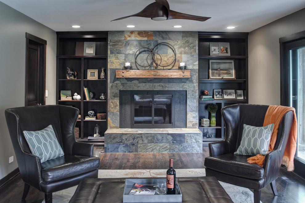 Transitional family room in Chicago with grey walls, dark hardwood floors, a standard fireplace and a stone fireplace surround.