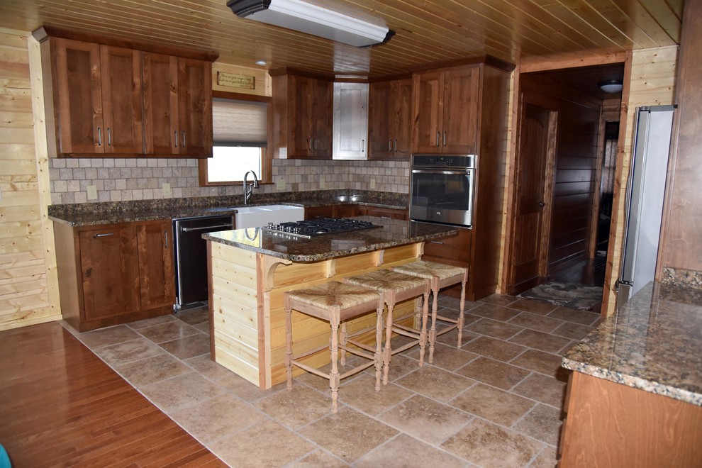 Mountain style eat-in kitchen photo with shaker cabinets and medium tone wood cabinets