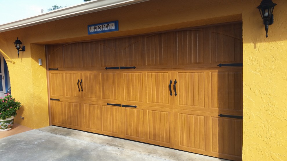 Photo of a mid-sized country attached two-car garage in Miami.