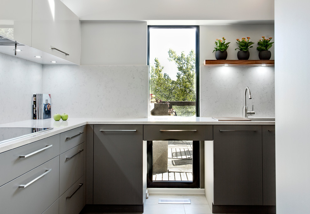 Contemporary l-shaped kitchen in Montreal with an undermount sink, flat-panel cabinets and grey cabinets.