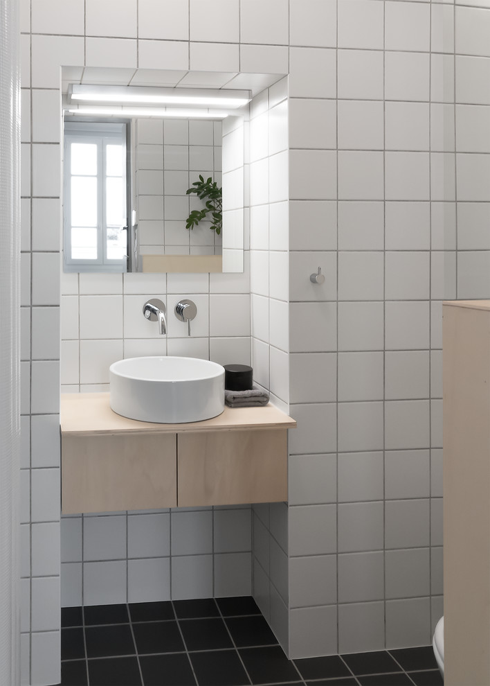 Design ideas for a small contemporary 3/4 bathroom with flat-panel cabinets, light wood cabinets, an open shower, a wall-mount toilet, white tile, ceramic tile, white walls, ceramic floors, a pedestal sink, wood benchtops, grey floor and a shower curtain.