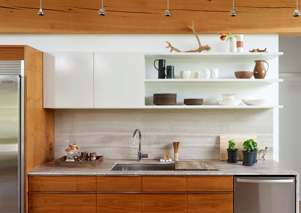 Inspiration for a large transitional single-wall light wood floor and exposed beam open concept kitchen remodel in Boston with an undermount sink, medium tone wood cabinets, marble countertops, beige backsplash, stone slab backsplash, stainless steel appliances, an island and beige countertops