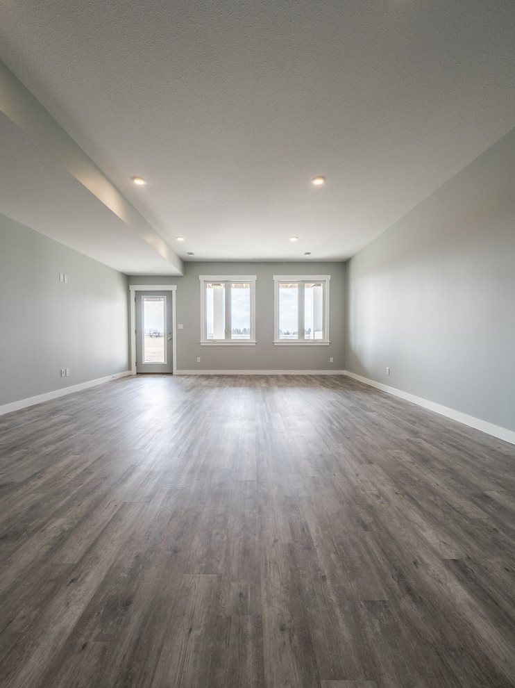 This is an example of a mid-sized modern open concept family room in Edmonton with grey walls, vinyl floors, grey floor and a game room.