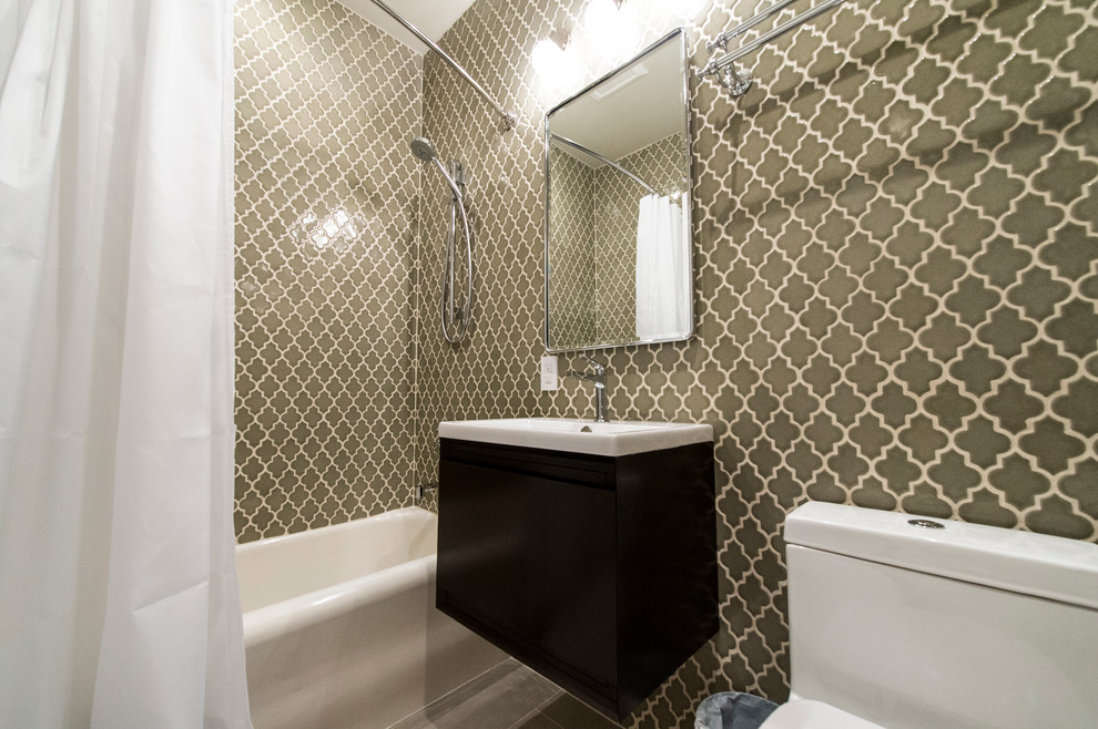 This is an example of a mid-sized contemporary 3/4 bathroom in San Francisco with flat-panel cabinets, dark wood cabinets, a shower/bathtub combo, green walls, an alcove tub, a two-piece toilet, beige tile, ceramic tile and a trough sink.