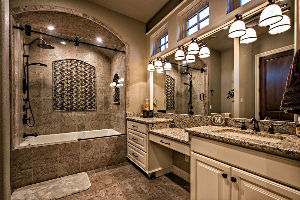 Inspiration for a large transitional master brown tile and porcelain tile porcelain tile and brown floor alcove bathtub remodel with raised-panel cabinets, beige cabinets, brown walls, an undermount sink and granite countertops