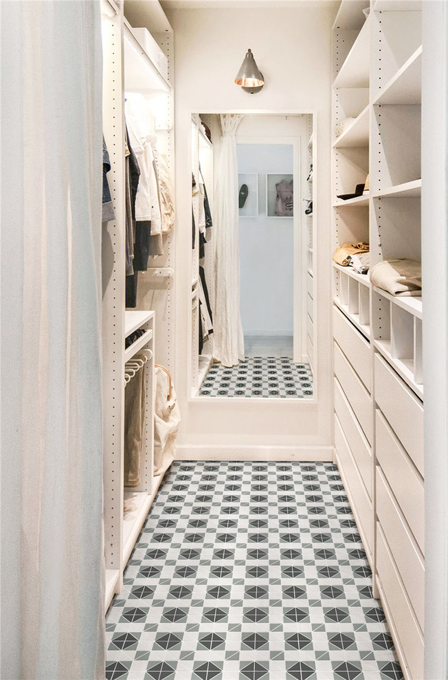 Contemporary gender-neutral walk-in wardrobe in Orange County with porcelain floors, multi-coloured floor, flat-panel cabinets and white cabinets.