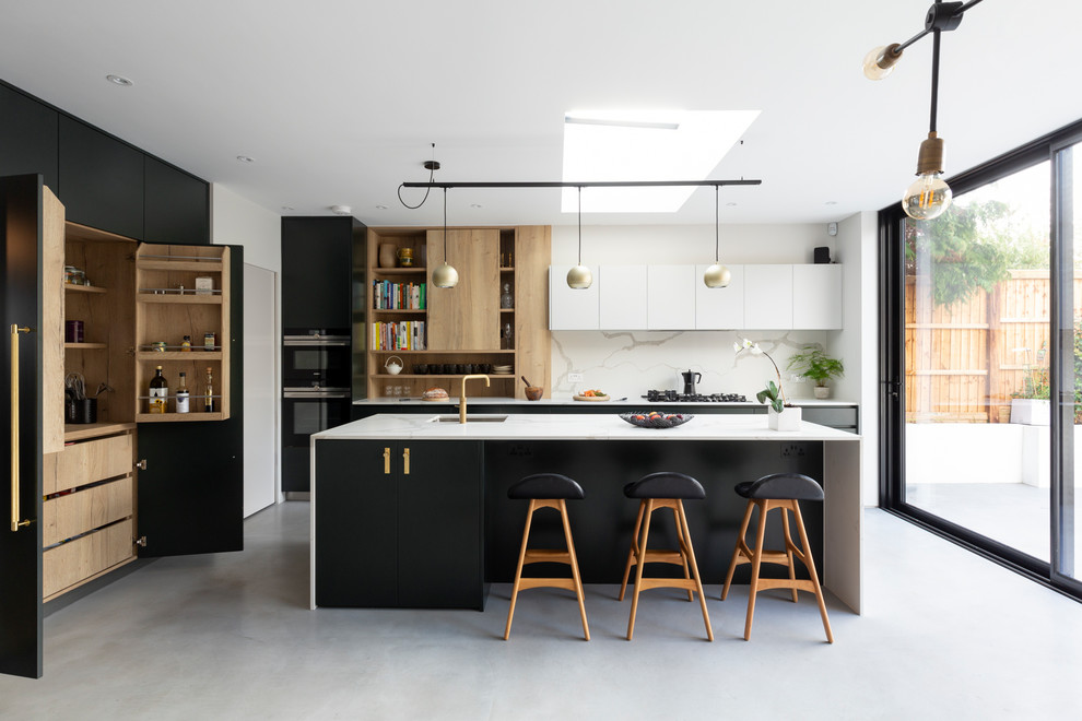 Photo of a mid-sized contemporary l-shaped open plan kitchen in London with an integrated sink, flat-panel cabinets, green cabinets, solid surface benchtops, white splashback, marble splashback, stainless steel appliances, porcelain floors, with island, grey floor and white benchtop.
