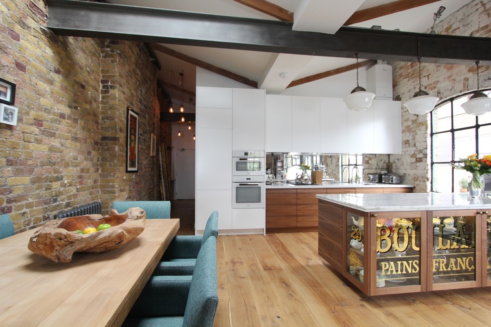 Inspiration for a large contemporary open plan dining in London with medium hardwood floors.