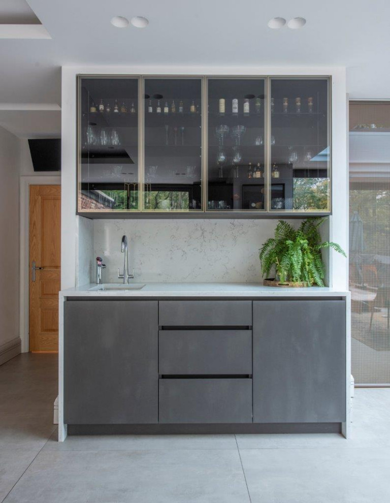 Design ideas for a large contemporary grey and brown l-shaped kitchen/diner in Manchester with a submerged sink, flat-panel cabinets, grey cabinets, quartz worktops, white splashback, granite splashback, black appliances, porcelain flooring, an island, grey floors, white worktops, a coffered ceiling and a feature wall.