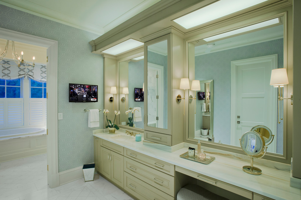 Design ideas for a large traditional master bathroom in Baltimore with a drop-in tub, a double shower, recessed-panel cabinets, beige cabinets, a two-piece toilet, blue walls, marble floors, a drop-in sink, laminate benchtops, white floor, a hinged shower door, white benchtops, white tile and marble.