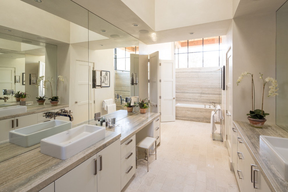 Design ideas for a contemporary master bathroom in Houston with flat-panel cabinets, an undermount tub, beige tile, beige walls, a vessel sink and white cabinets.