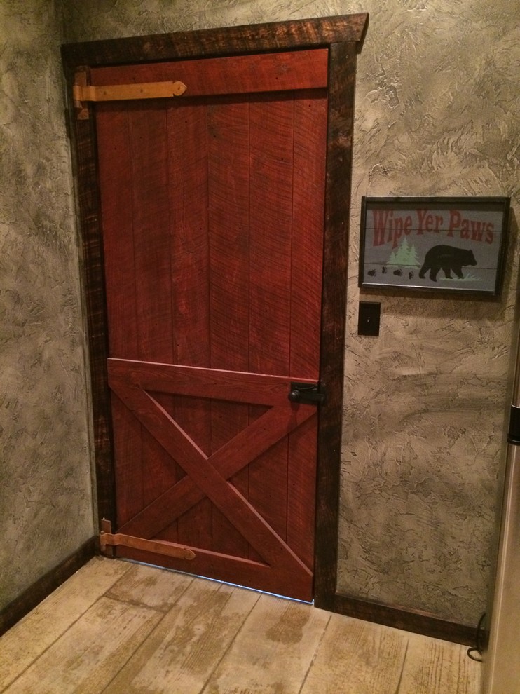 Example of a small mountain style light wood floor and beige floor front door design with a red front door and brown walls