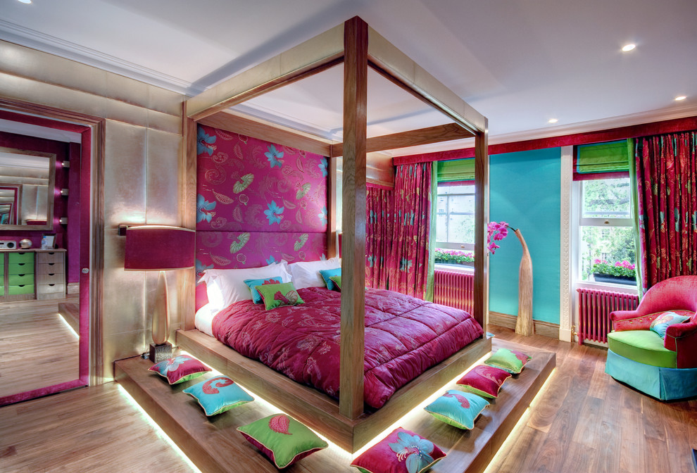 This is an example of a large asian master bedroom in London with no fireplace and multi-coloured walls.