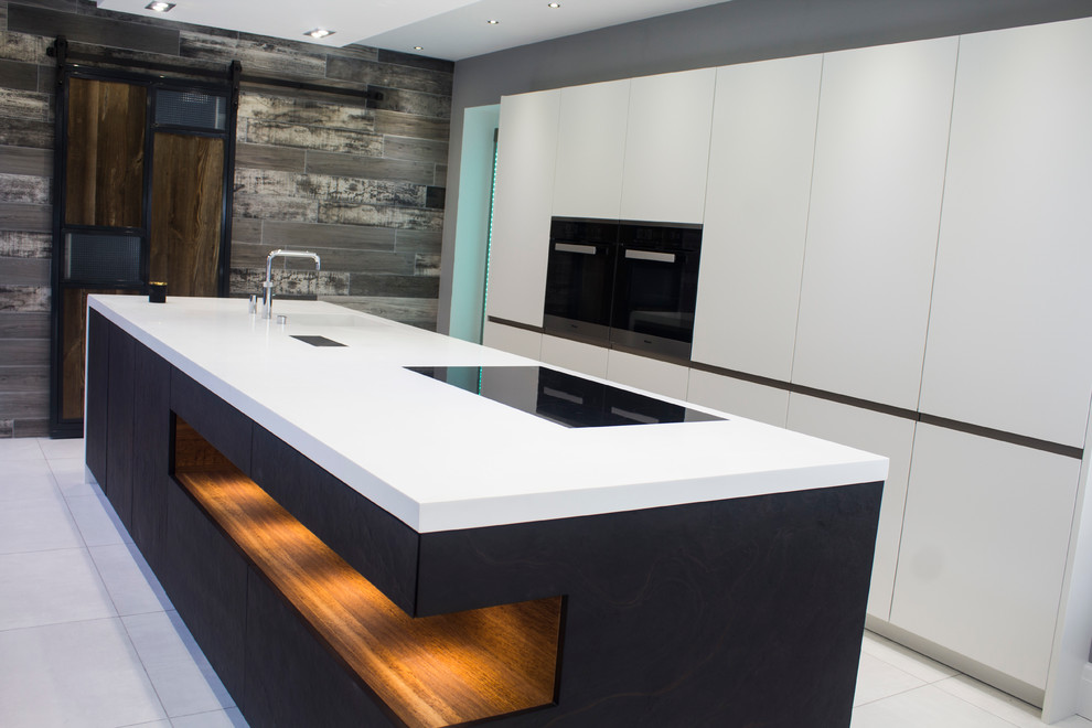 Photo of a large contemporary single-wall open plan kitchen in Other with with island, flat-panel cabinets, white cabinets, black appliances, porcelain floors and an integrated sink.