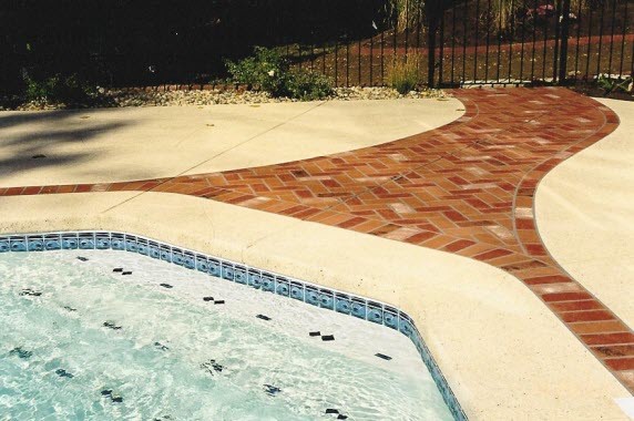 Large mediterranean backyard custom-shaped aboveground pool in Nashville with a water feature and concrete pavers.