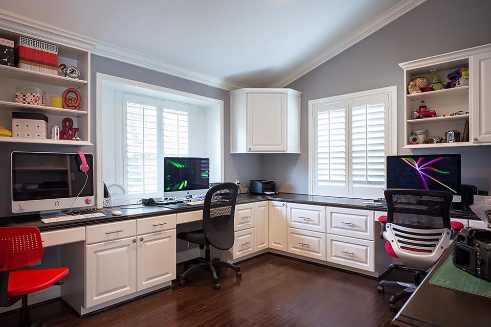 Traditional study room in Houston with dark hardwood floors and a built-in desk.