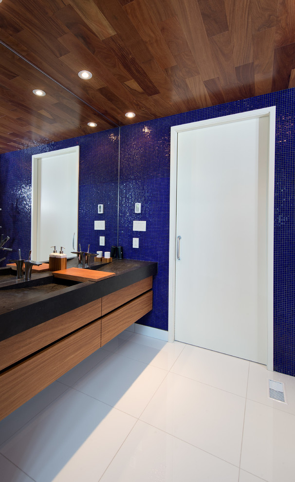 Photo of a large contemporary bathroom in Montreal with flat-panel cabinets, an open shower, a one-piece toilet, black and white tile, ceramic tile, blue walls and ceramic floors.