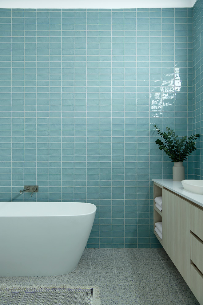 This is an example of a mid-sized beach style kids bathroom in Perth with light wood cabinets.